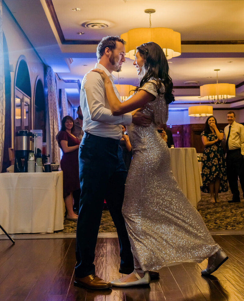 Man and woman dancing together at a reception.