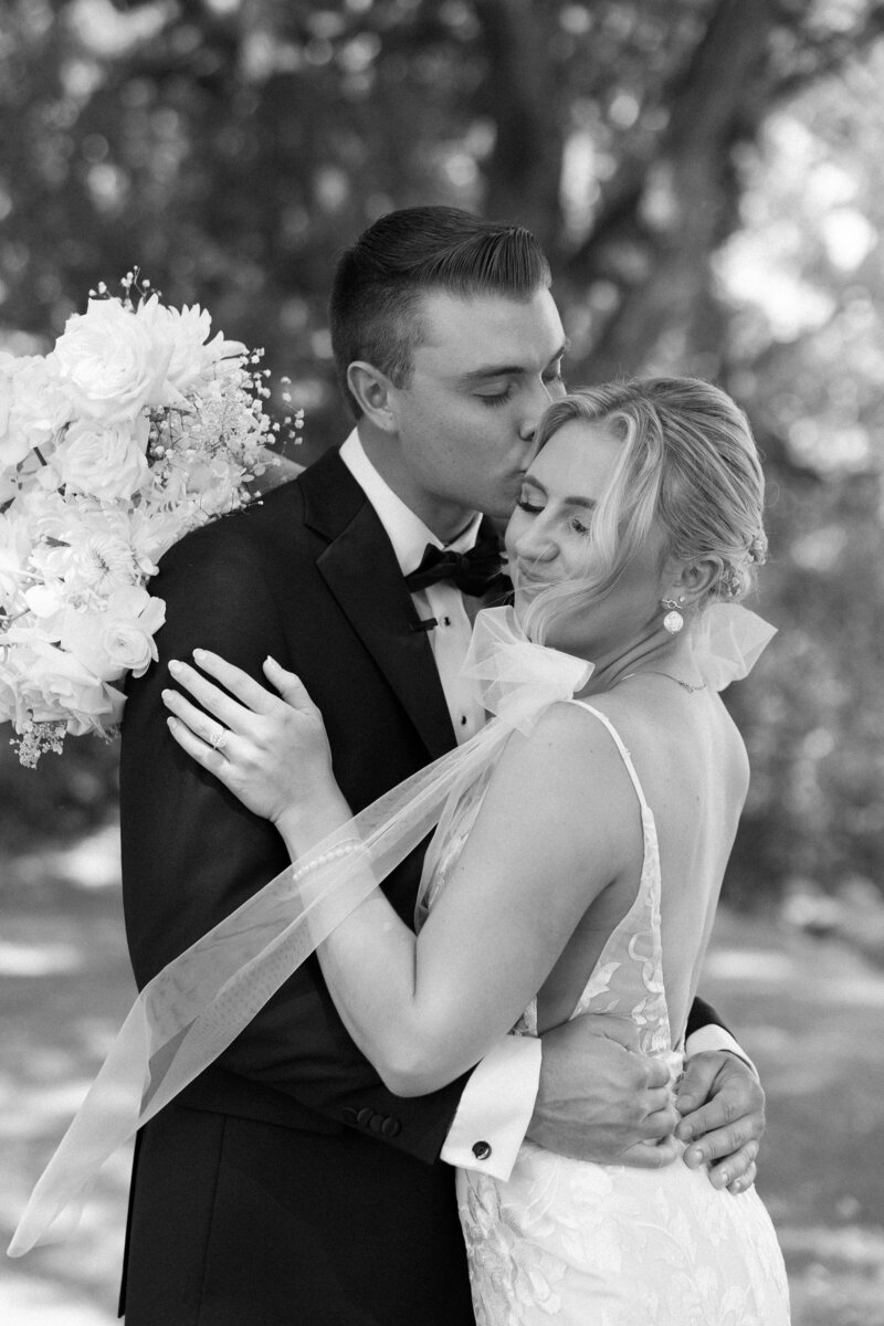 Bride and groom sharing a quiet moment, embracing each other lovingly, captured by a Madison wedding photographer.