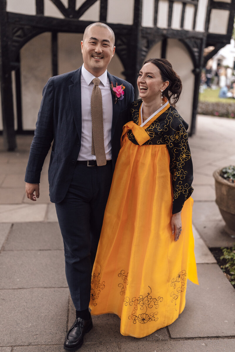 Wedding photographer captures couple taking a stroll hand in hand at their french chateau wedding.