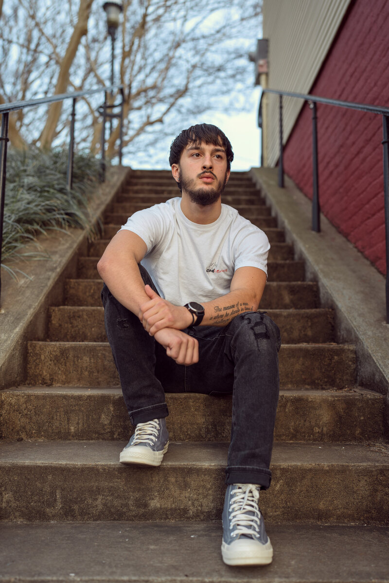 A high school senior poses for his senior portrait photos at Libby Hill Park in Richmond, Virginia