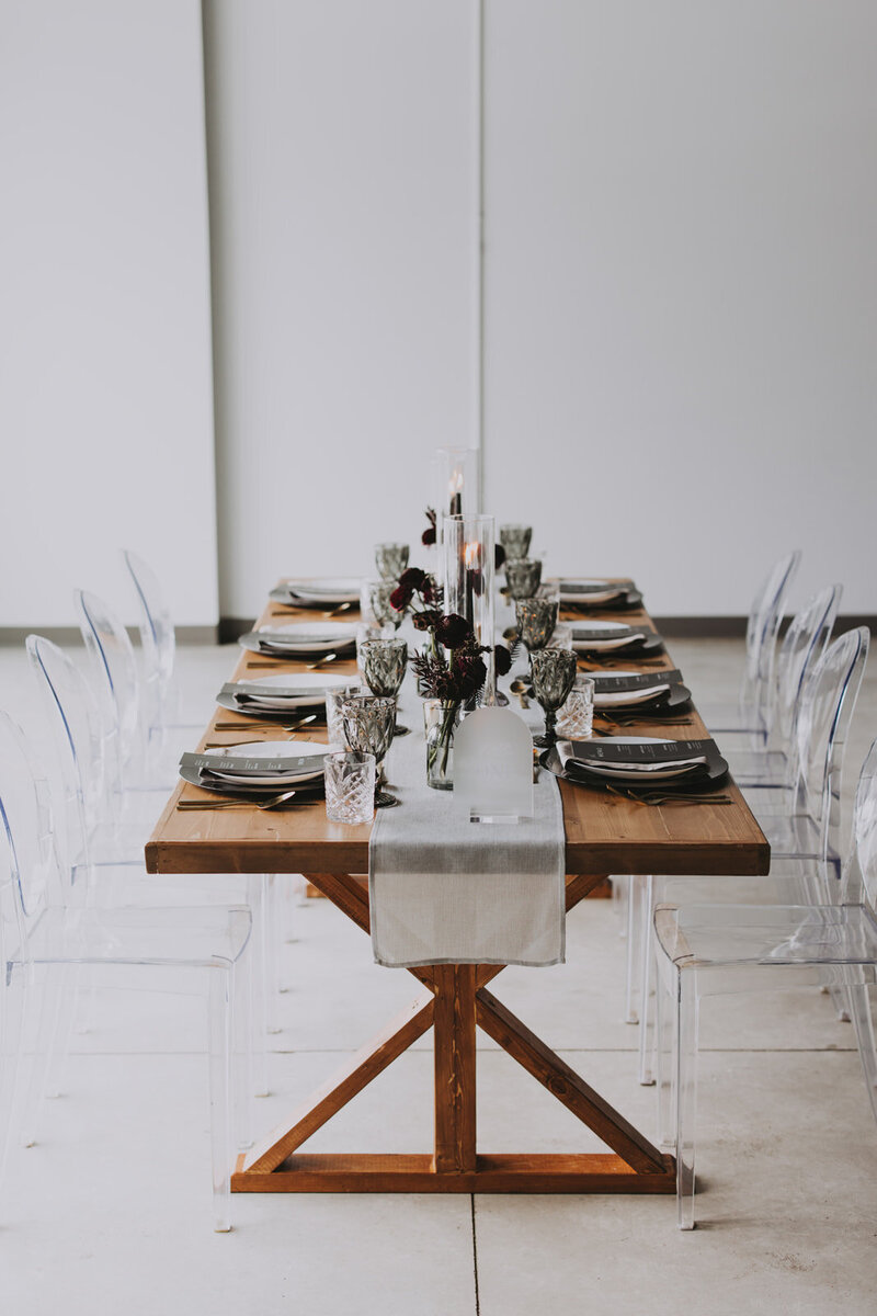 Bright floral centerpiece with pink roses, orange blossoms, and natural greenery styled for a modern Rocky Mountain wedding.