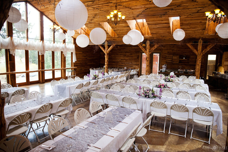 Long Tables set up for wedding reception inside barn at Wedgewood Weddings Mountain View Ranch