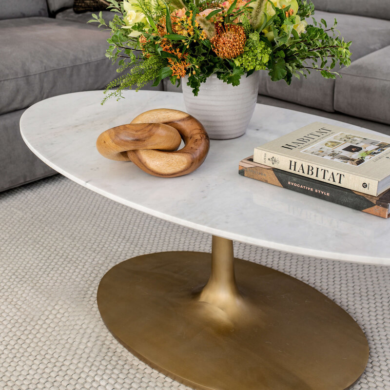 Mid-century modern lower level transformation in Wrentham MA by Glass House Design Group. Layered textiles, mixed materials (marble, brass, wood, concrete), custom maple wall slats, and buttery leather lounge seating. Greater Boston interior design that creates mood, not just rooms.