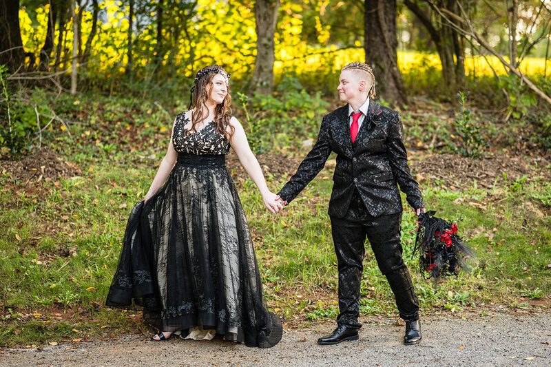 An LGBTQ+ couple walks hand-in-hand and smile at one another on their elopement wedding day in Roanoke, Virginia.