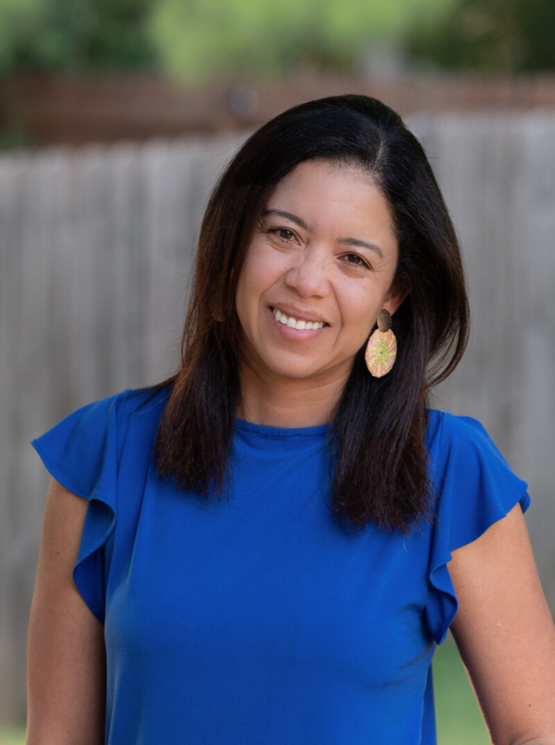 female looking at camera, arms crossing and smiling