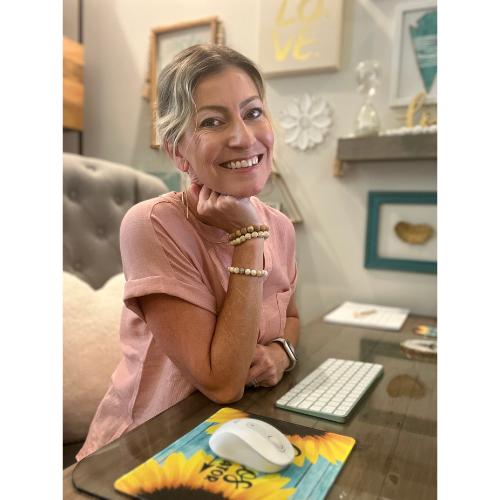 Jill smiling while sitting at her desk