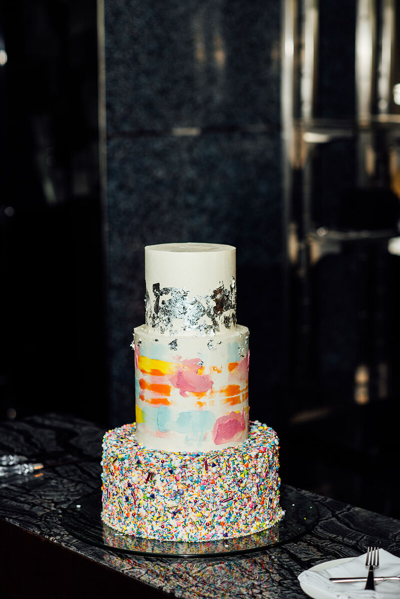 A line of people with their arms around each other kicking the legs out.