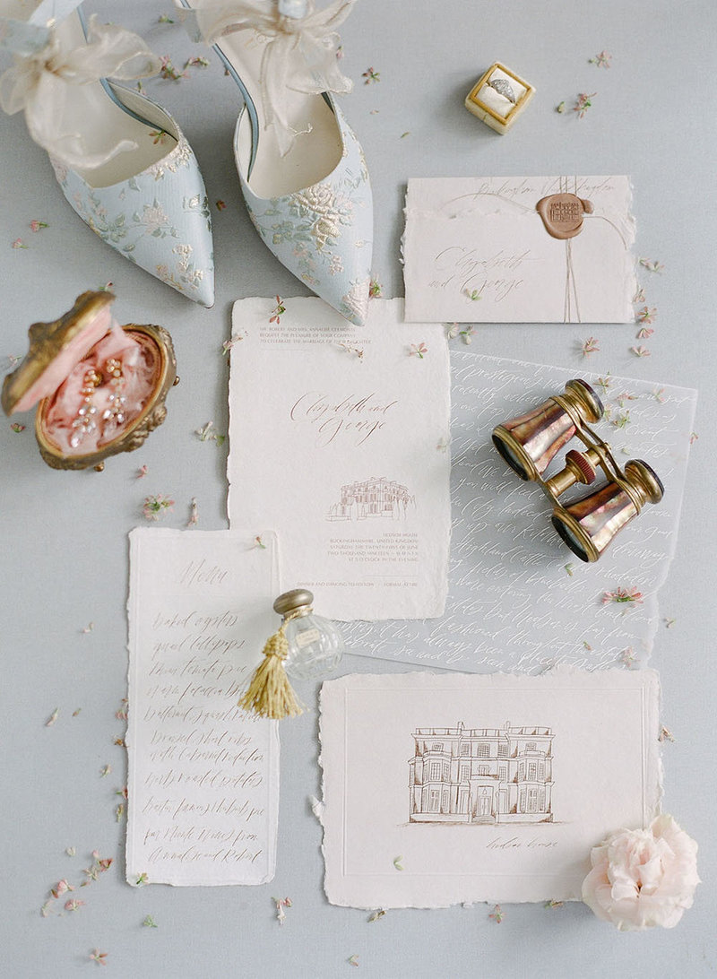 Deckle edge wedding invitations with handwritten calligraphy, venue illustrations and chinoiserie bridal heels