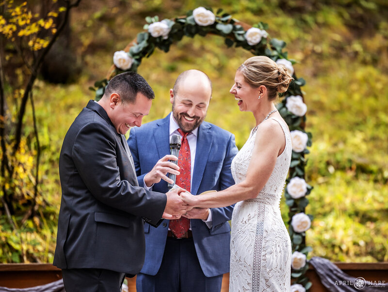 Cute Couple Laugh at their Beaver Ranch Wedding During Autumn in CO