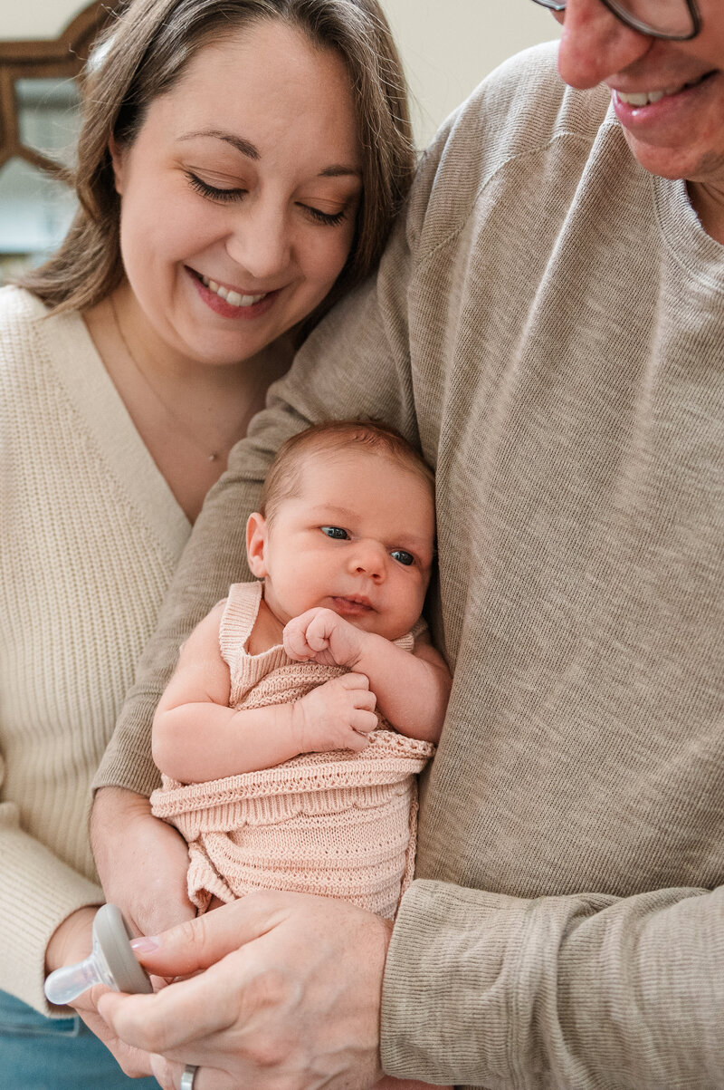 mother and father holding baby by newborn photography baltimore md