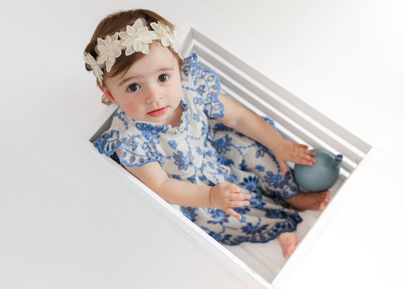Light and airy lifestyle portrait of a baby at a 1st birthday cake smash photo session at Allison Reilly's Union County, NJ photo studio.