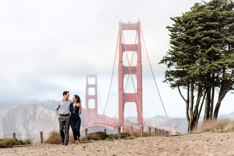 Couple walking in front of the golden gate bridge
