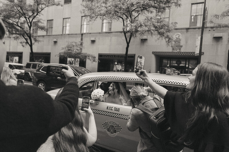 bride and groom leaving in a taxi after eloping shot by Elsie Goodman Photography | NYC Elopement Packages