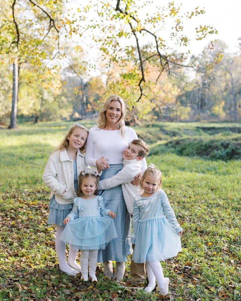 Stephanie Houseal and her four children pose in a scenic outdoor setting. The heart behind Moments in Light Photography, est. 2014.