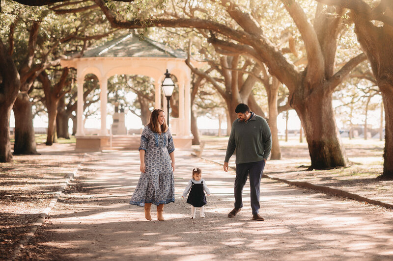 Parents walk with their toddler during Family Photoshoot in Charleston.