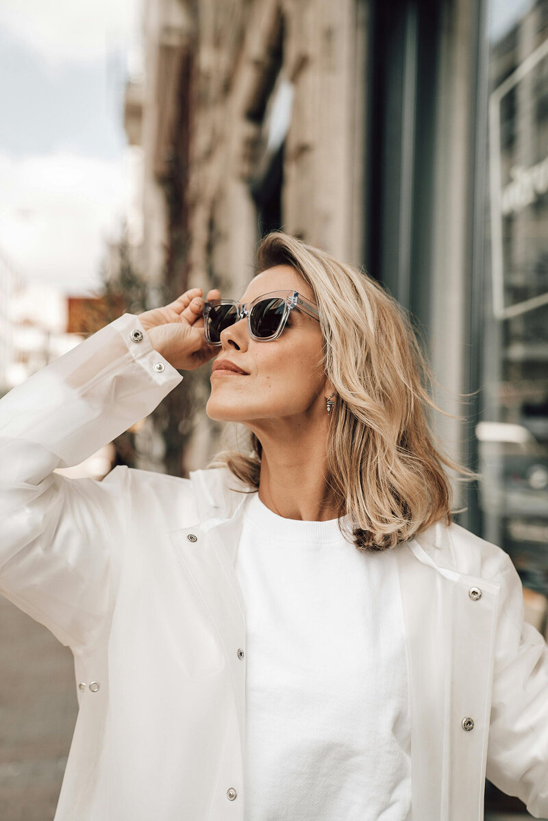 Close-up of a woman adjusting her sunglasses, looking toward the future with expert financial insights from Kim Russell at Ataraxis Financial. Say goodbye to financial chaos and hello to clarity, growth, and peace of mind with strategic bookkeeping solutions designed for business expansion.