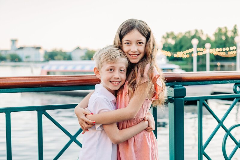 brother and sister hugging and smiling at Disney's Boardwalk resort