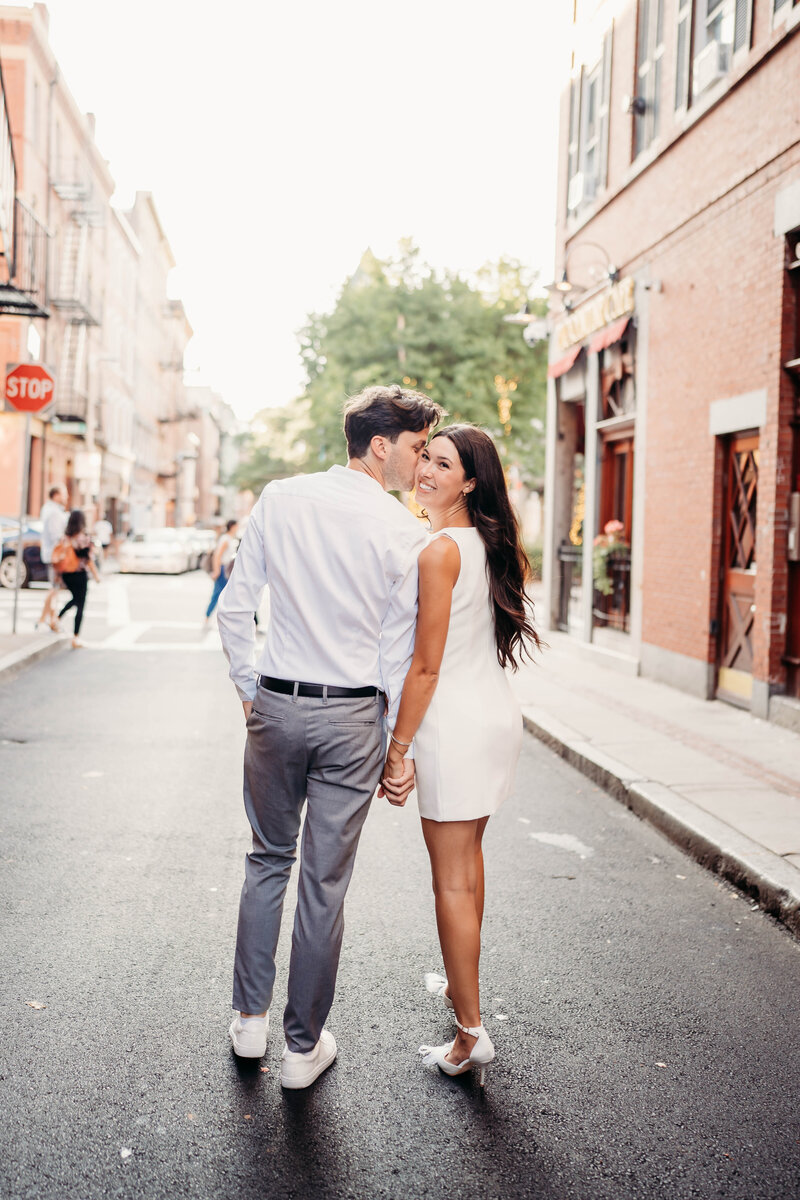 A romantic engagement session in Boston’s historic North End, capturing love in the charming cobblestone streets and iconic city scenery. This dreamy golden-hour shoot showcases an elegant couple sharing sweet moments against a picturesque backdrop of red brick buildings, cozy cafés, and classic New England charm. Perfect inspiration for engaged couples seeking a timeless and intimate city engagement session.