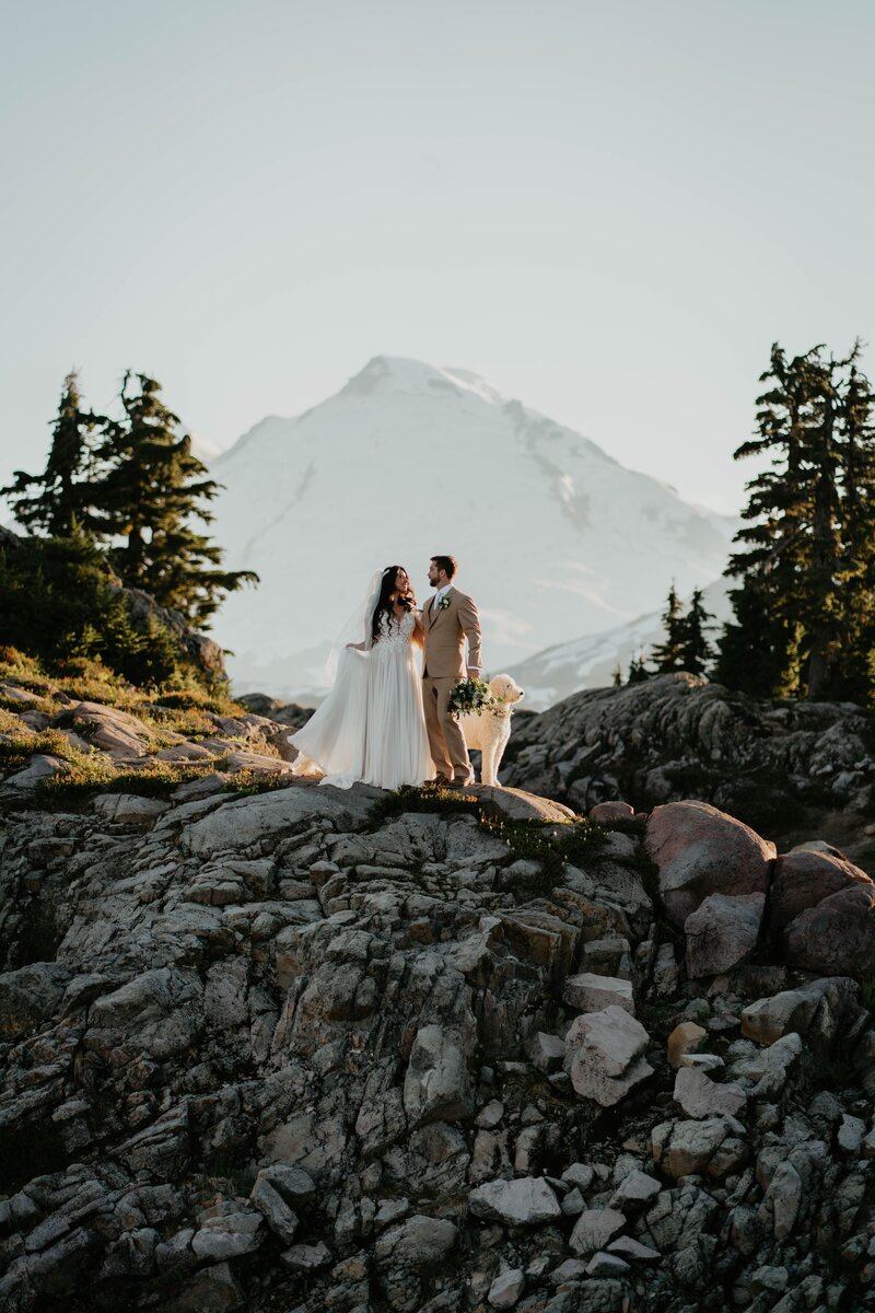 Couple standing with their dog in the North Cascades mountains