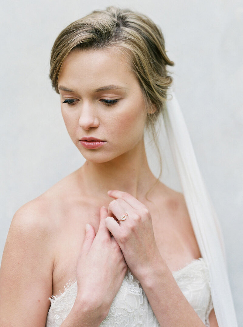 Bride wearing a veil looking down and away from camera