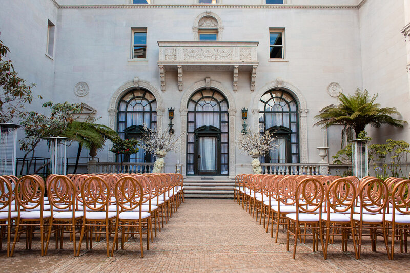 Wedding ceremony setup with gold chairs at historic Flood Mansion courtyard - San Francisco wedding photographer