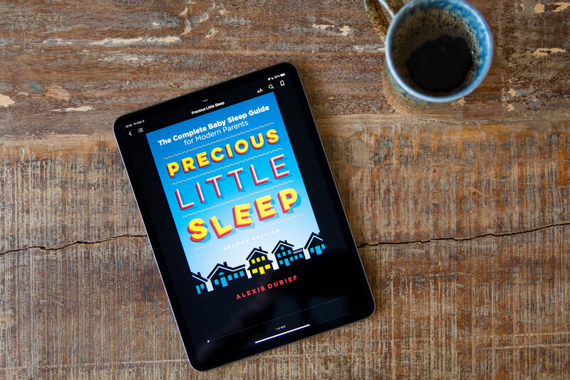 ebook cover of precious little sleep on an iPad that is laid on a wooden table