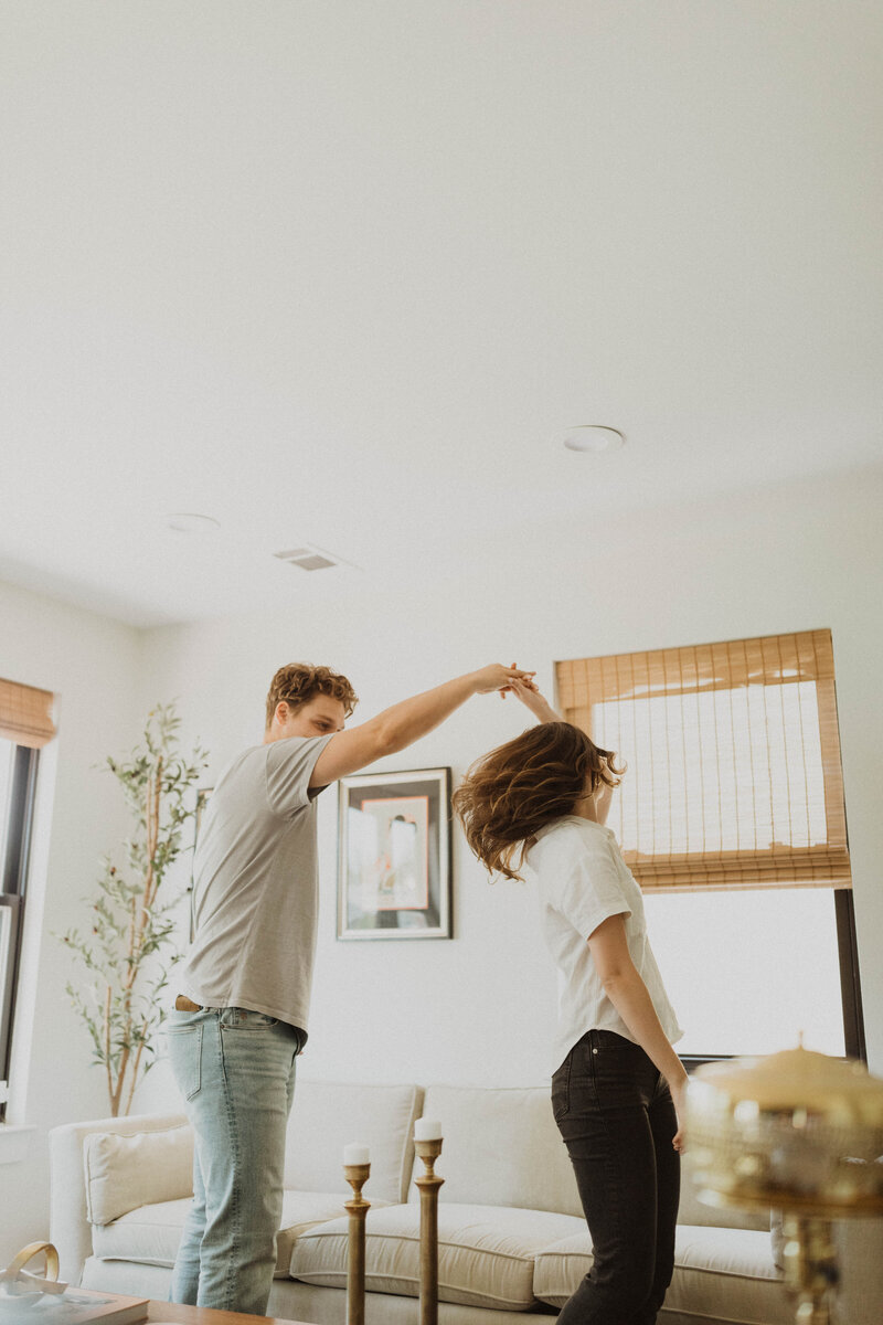 couple jumping in front of building