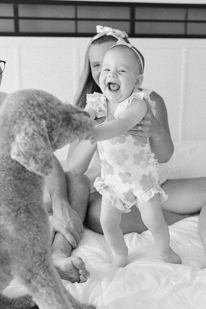 baby playing with dog