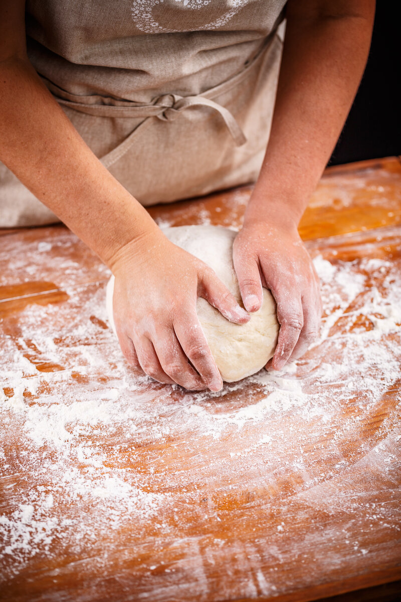 female-hands-making-bread-dough-4BAN5JT