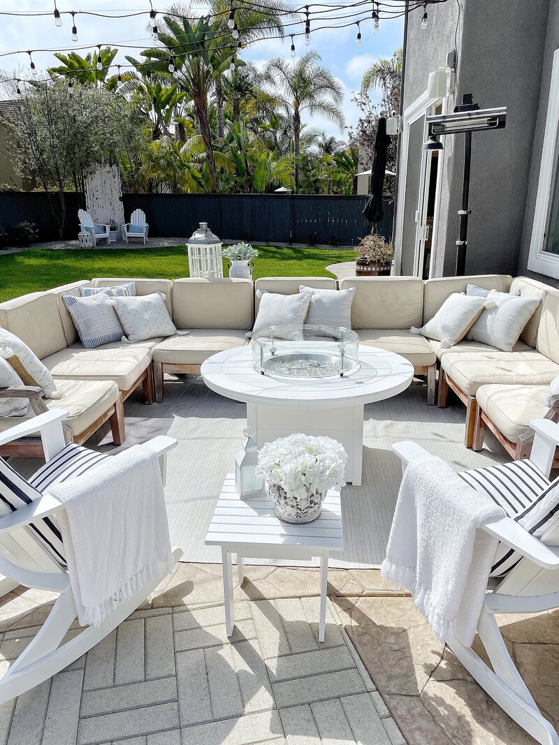 outdoor sectional with rocking chairs and a fireplace