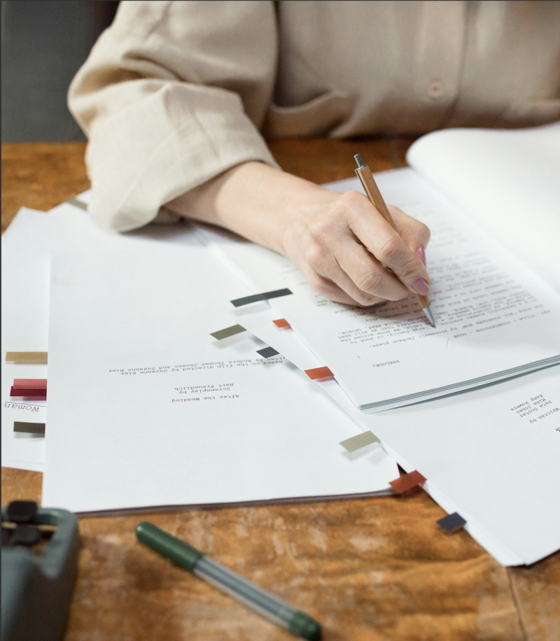 Professional copy editor reviewing a document and making detailed edits, ensuring accuracy, clarity, and polished final content through expert proofreading services.