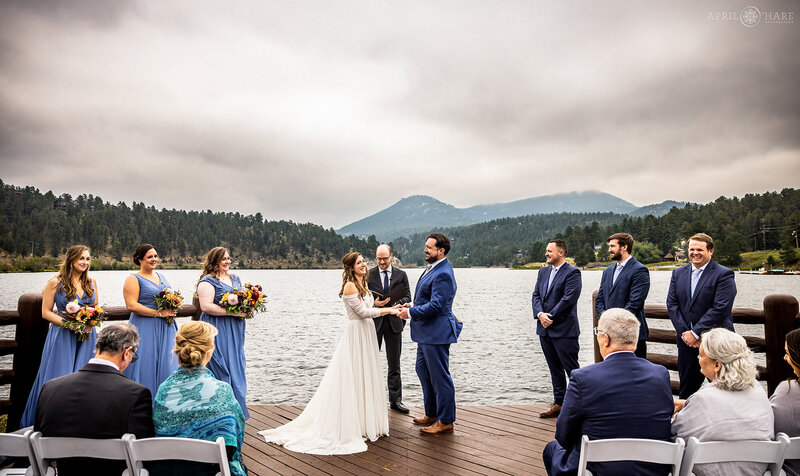 Overcast wedding day on the wood deck at Evergreen lake house in Colorado