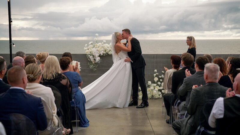 california wedding video still bride and groom kissing at ceremony