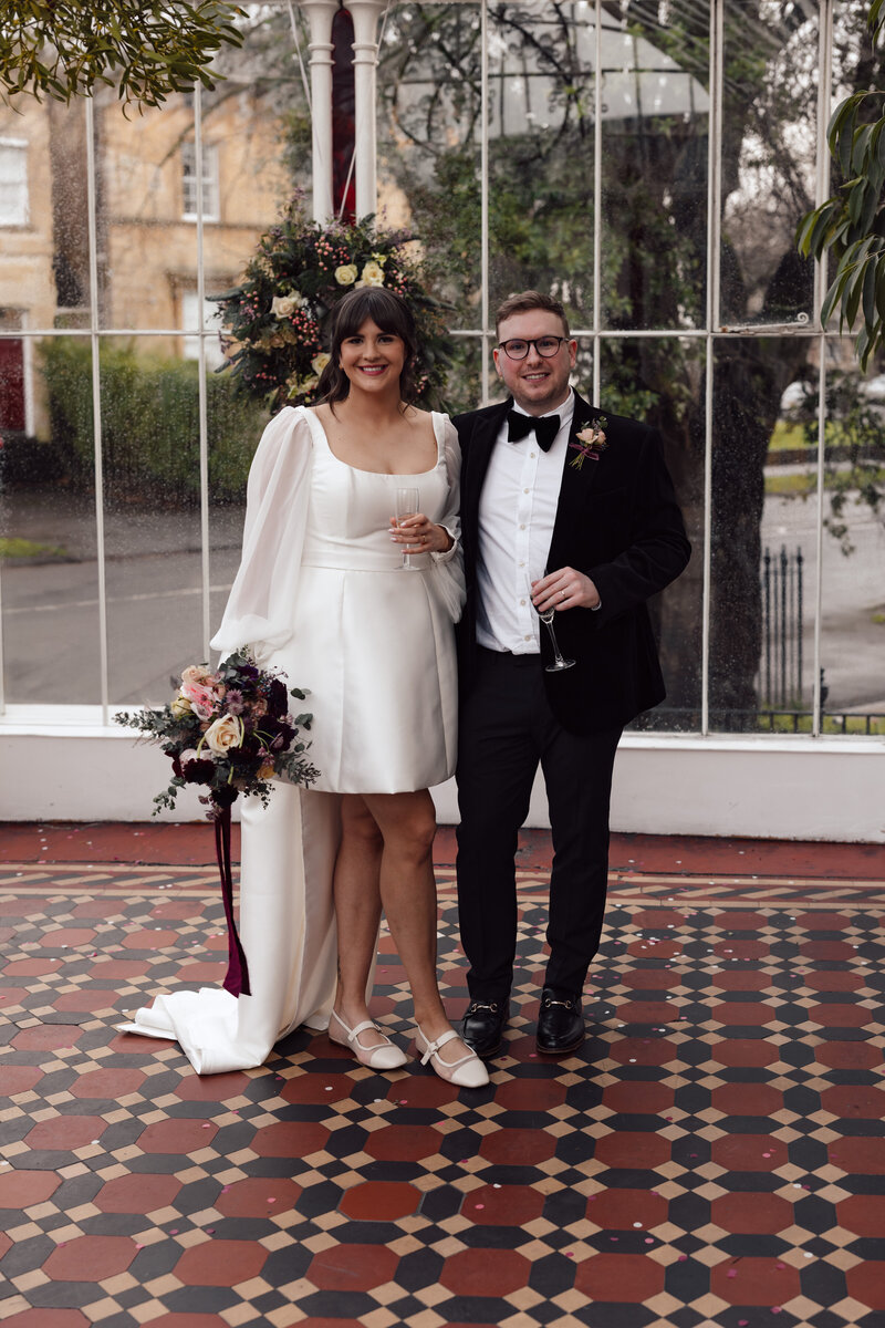 An emotional bride hugs her husband at their luxury wedding reception in the cotswolds