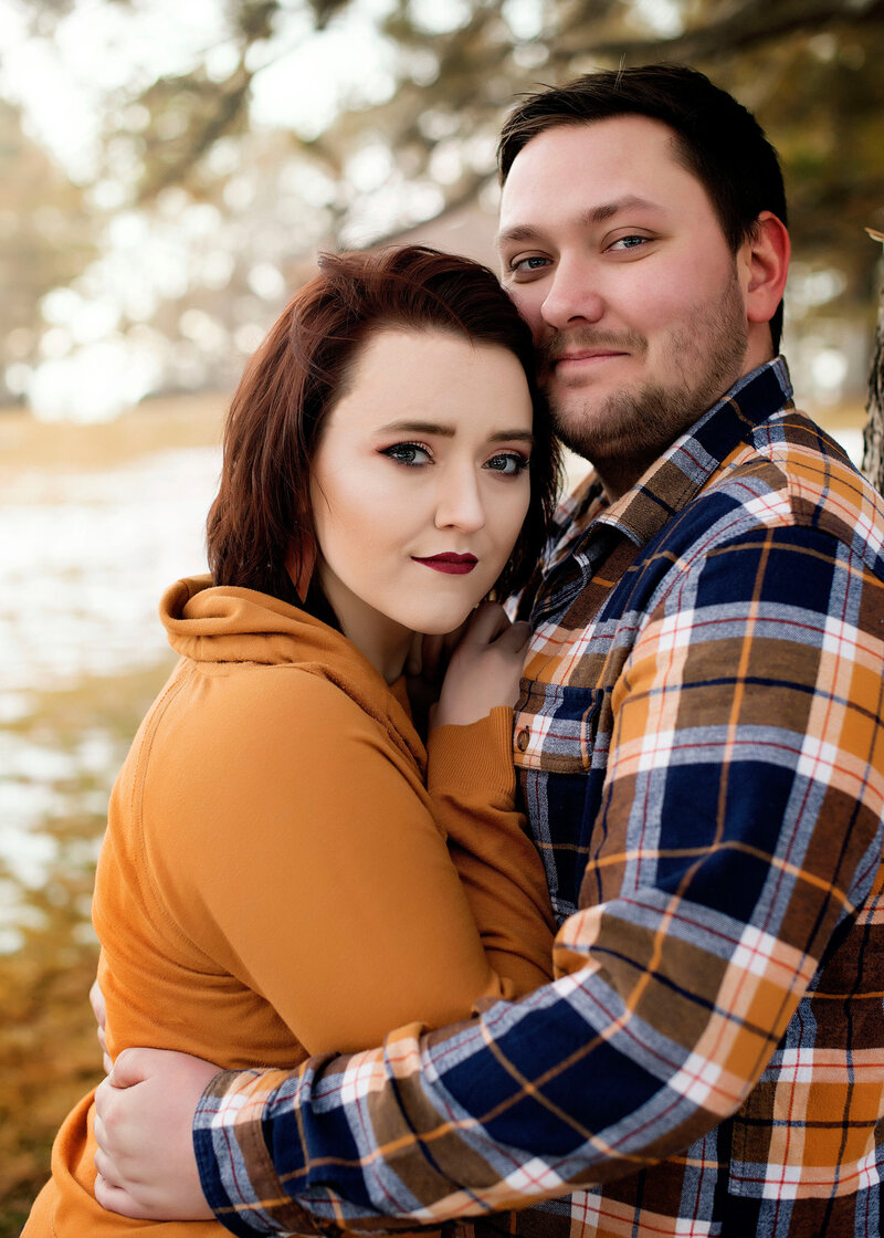 Couple holding each other and facing the camera.