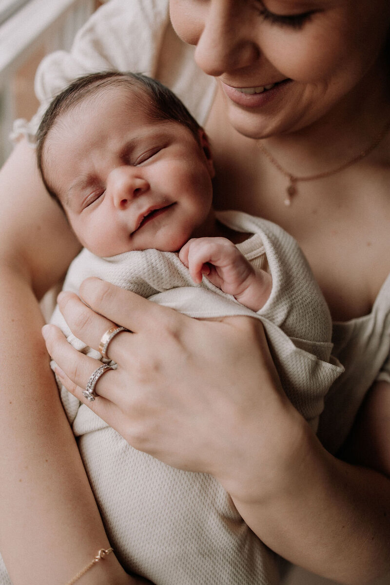 Newborn baby held in mums arms