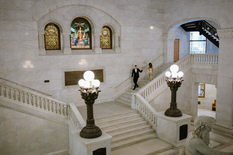 Candid moment of couple during editorial-style City Hall engagement shoot in Minnesota
