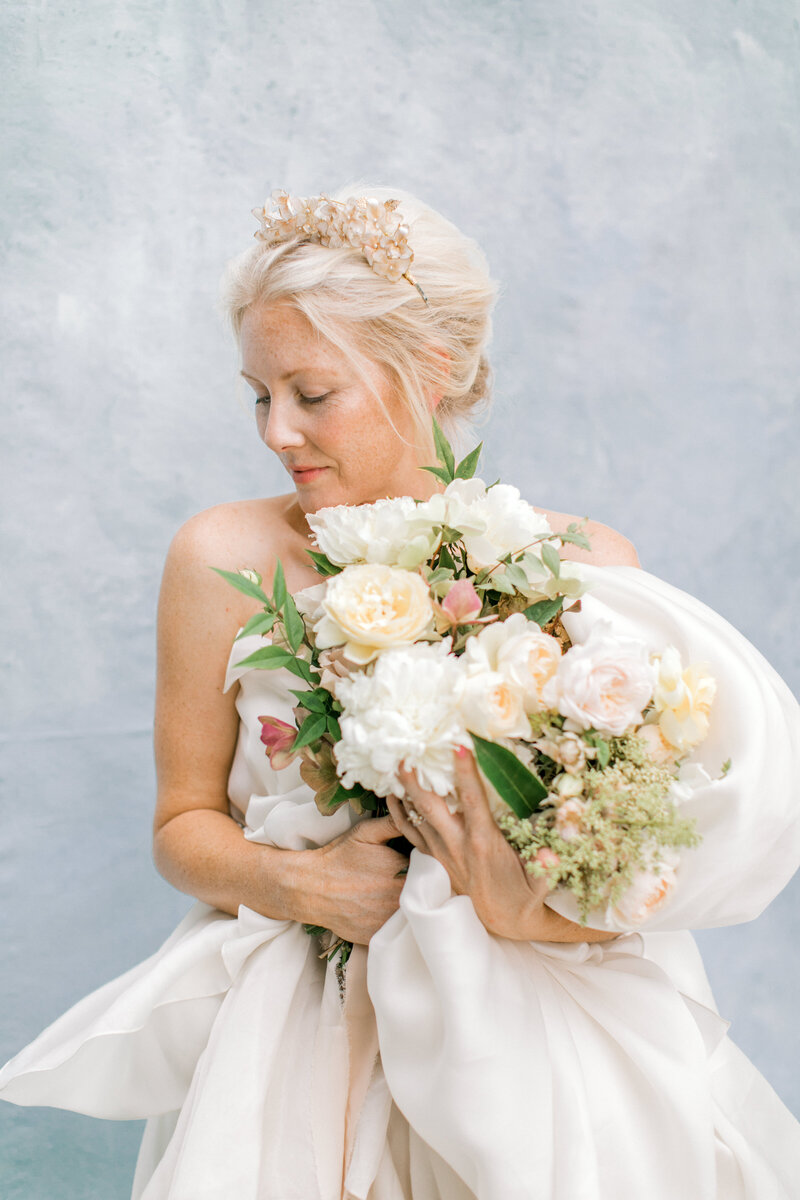 Beautiful bride with tiara and bridal bouquet with peonies