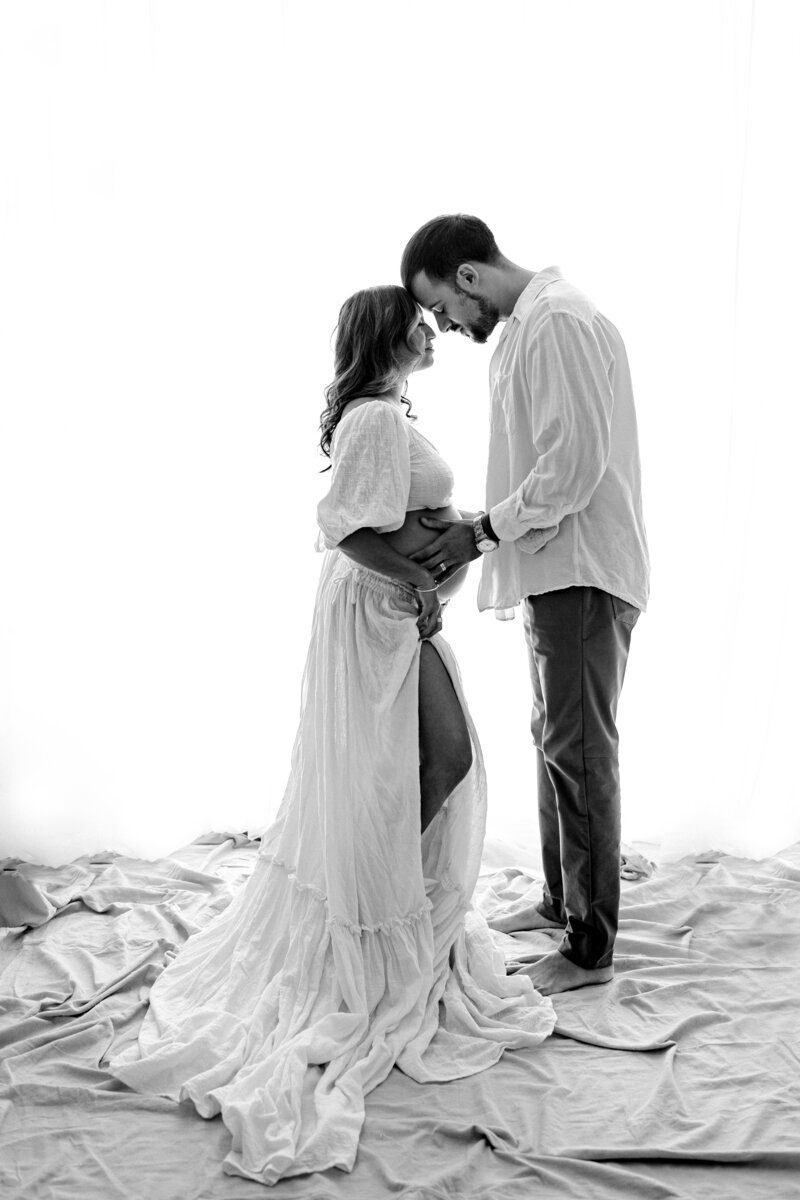 Maternity photography couples photo pregnant woman with husband with boho background in Tampa Bay, Florida Nadine B Photography