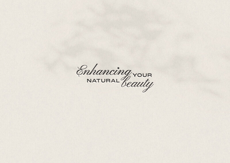 "Enhancing your natural beauty" tagline embossed on paper
