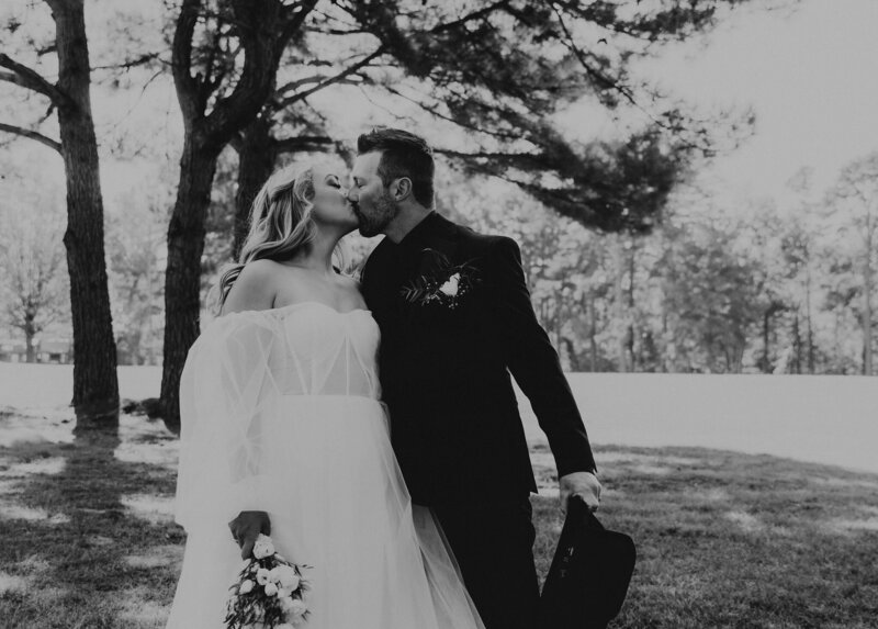 Bride and Groom kissing in the  outdoor ceremony at The Rosewood Venue.
