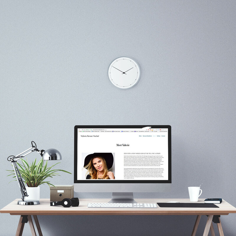 desktop computer with female actor website on screen in modern office