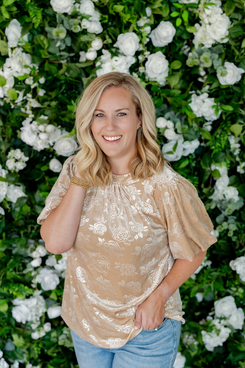 Woman in front of green and white wall.