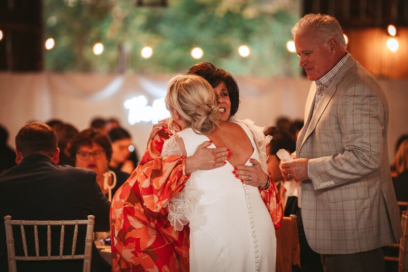 bride hugging mom - baltimore wedding photographer