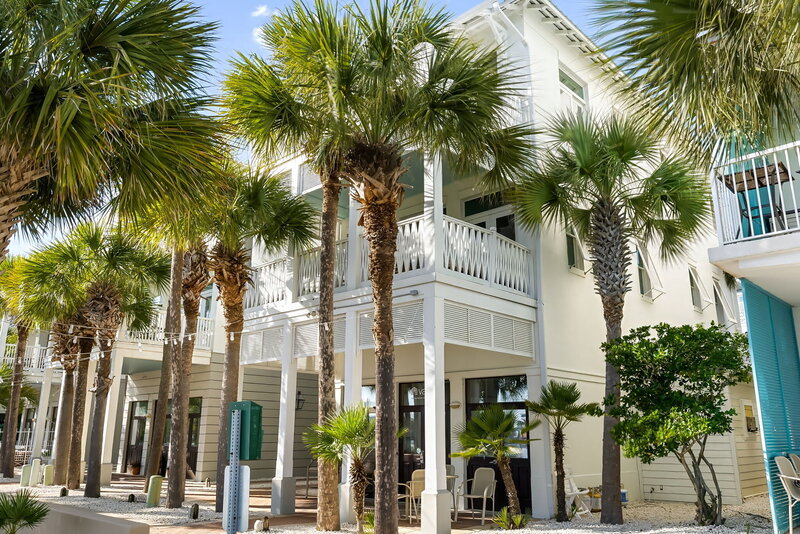 Charming coastal vacation rental surrounded by palm trees in downtown Carillon Beach, just minutes from Panama City Beach and 30A. The Florida House offers vibrant beach living.