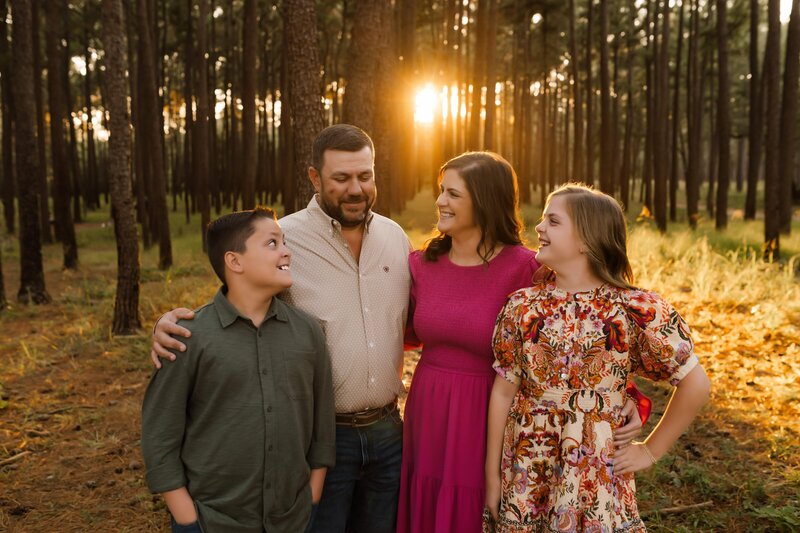 picture of a family standing in a country greenhouse during golden hour captured by shelly voss photography