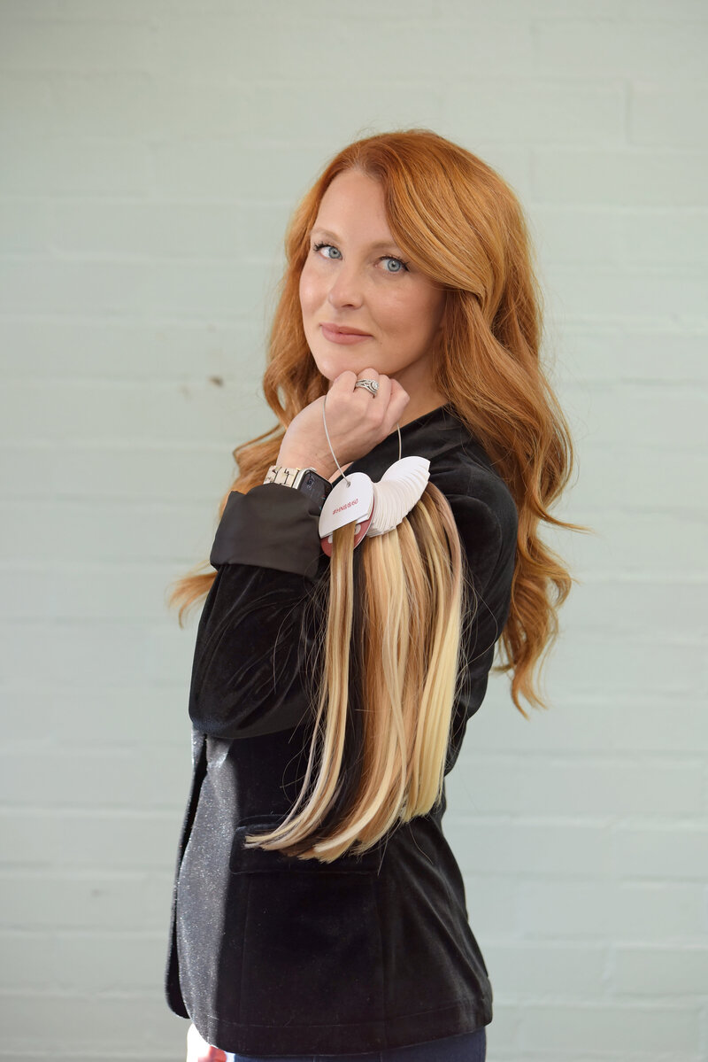 Erica holding samples of hair extensions