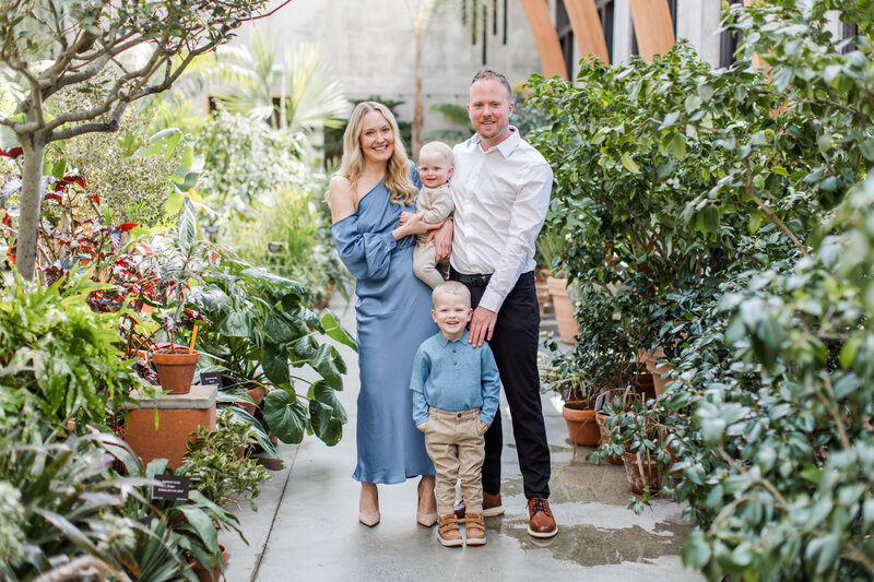 family standing together in botanical garden