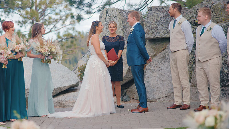 A happy couple getting married in Lake Tahoe looks into each other's eyes as they are pronounced husband and wife - Films by Brian