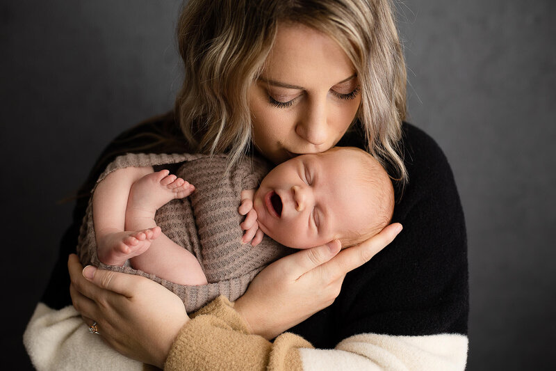Mom and new baby boy during their newborn photography session.